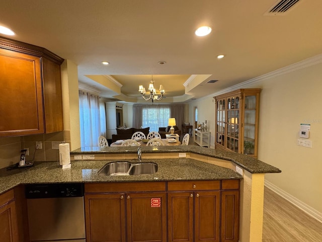 7651 Whisper Way Unit 201, Kissimmee, FL 34747 - kitchen with stainless steel dishwasher, a sink, ornamental molding, a raised ceiling, and a chandelier