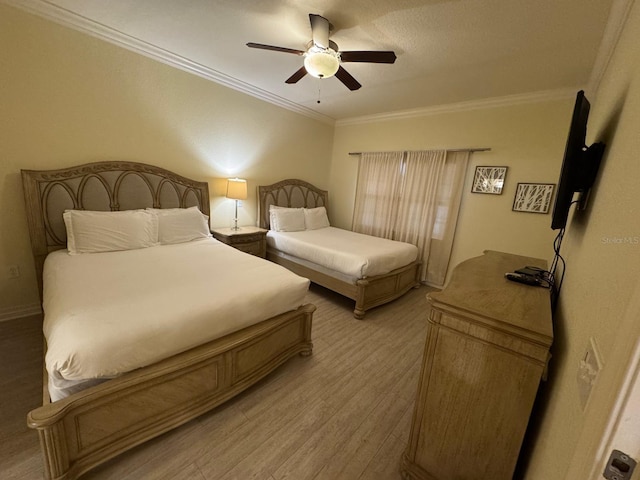 7651 Whisper Way Unit 201, Kissimmee, FL 34747 - bedroom with ornamental molding, light wood-style flooring, and ceiling fan
