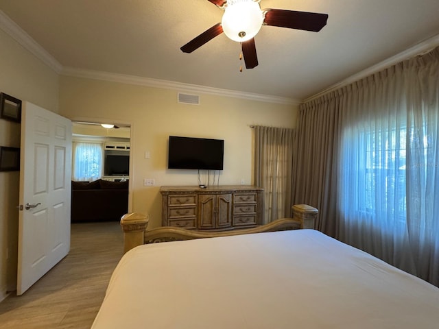 7651 Whisper Way Unit 201, Kissimmee, FL 34747 - bedroom with crown molding, light wood-style flooring, and a ceiling fan