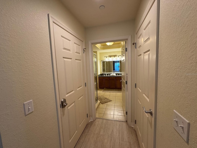 7651 Whisper Way Unit 201, Kissimmee, FL 34747 - corridor featuring a textured wall and light wood-style floors