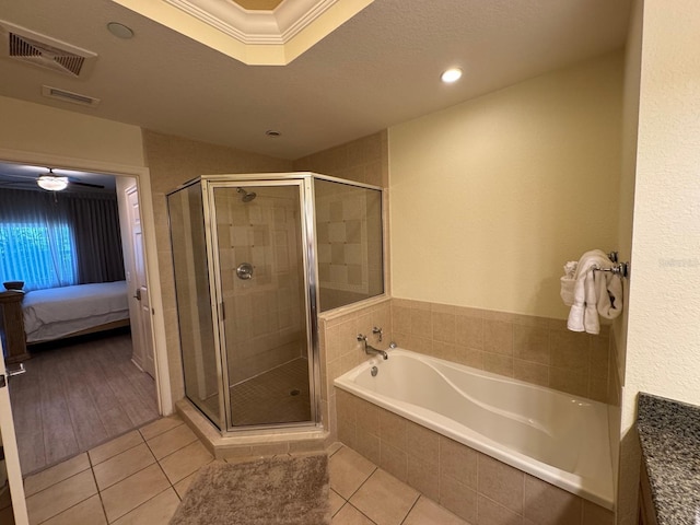 7651 Whisper Way Unit 201, Kissimmee, FL 34747 - bathroom with a garden tub, tile patterned floors, a shower stall, ensuite bath, and ornamental molding