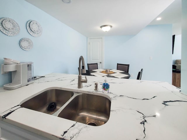 215 Medallion Blvd Unit G, Madeira Beach, FL 33708 - kitchen featuring a sink and light stone counters