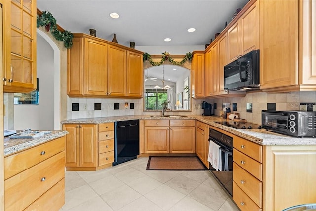206 Islandia Ct Unit U206, Satellite Beach, FL 32937 - kitchen featuring black appliances, arched walkways, decorative backsplash, light stone counters, and recessed lighting