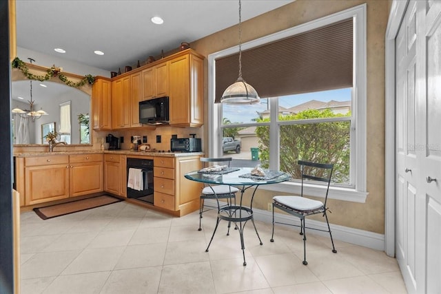 206 Islandia Ct Unit U206, Satellite Beach, FL 32937 - kitchen with black appliances, plenty of natural light, hanging light fixtures, and recessed lighting