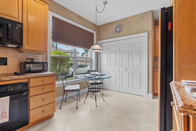 206 Islandia Ct Unit U206, Satellite Beach, FL 32937 - kitchen with black appliances, light tile patterned flooring, backsplash, and baseboards