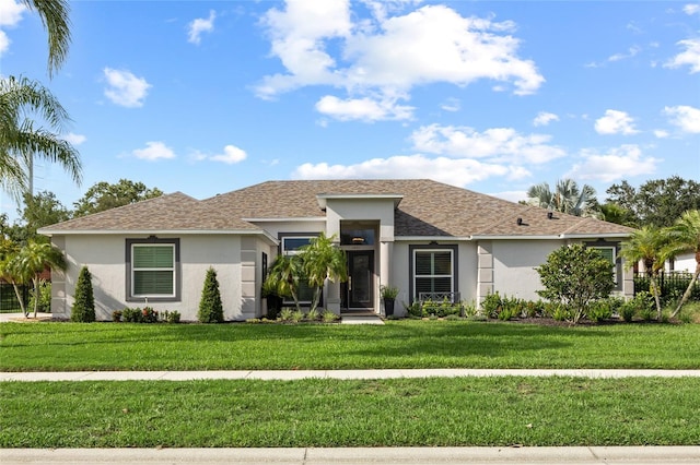1301 Johns Cove Ln, Oakland, FL 34787 - view of front facade with stucco siding, a front lawn, and a shingled roof
