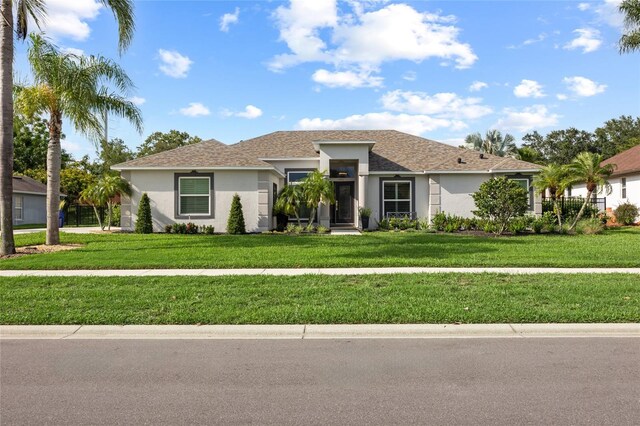 1301 Johns Cove Ln, Oakland, FL 34787 - ranch-style house featuring stucco siding and a front lawn
