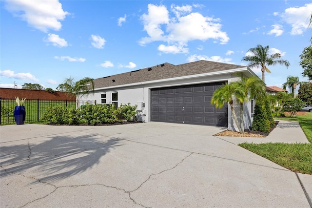 1301 Johns Cove Ln, Oakland, FL 34787 - view of home's exterior featuring a garage, driveway, and stucco siding