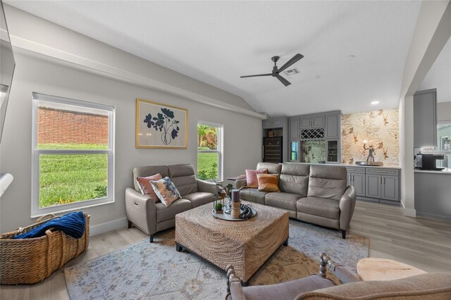 1301 Johns Cove Ln, Oakland, FL 34787 - living room featuring ceiling fan, vaulted ceiling, light wood-style flooring, and baseboards