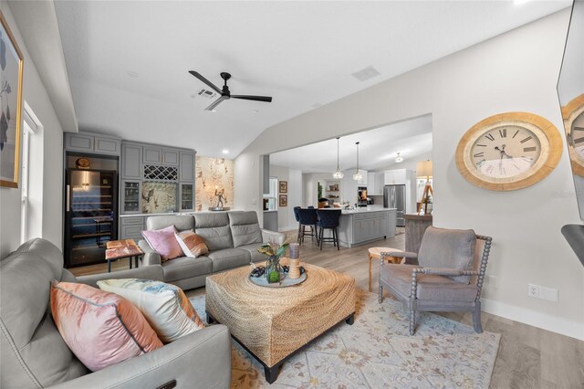 1301 Johns Cove Ln, Oakland, FL 34787 - living room featuring a ceiling fan, light wood finished floors, vaulted ceiling, and baseboards
