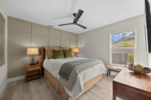 1301 Johns Cove Ln, Oakland, FL 34787 - bedroom featuring light wood-type flooring, a textured ceiling, and a ceiling fan