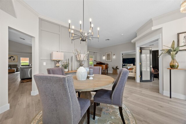 1301 Johns Cove Ln, Oakland, FL 34787 - dining area featuring light wood-style floors, a chandelier, baseboards, and ornamental molding