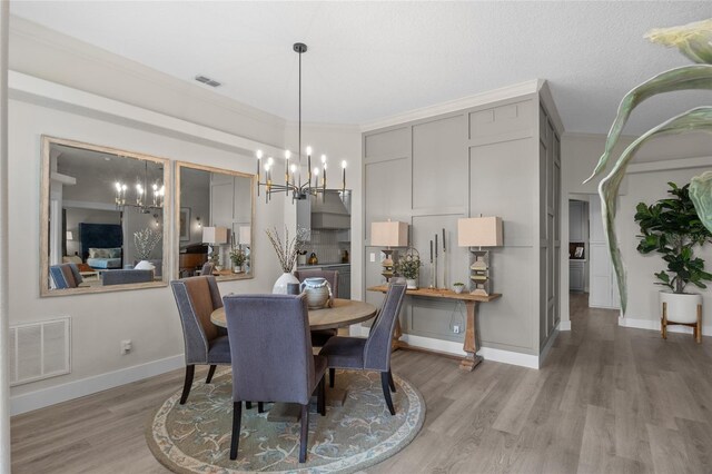 1301 Johns Cove Ln, Oakland, FL 34787 - dining room featuring a chandelier, light wood-style flooring, baseboards, and crown molding