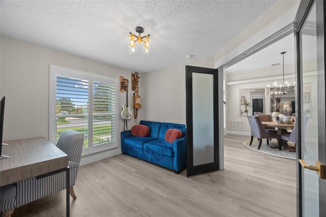 1301 Johns Cove Ln, Oakland, FL 34787 - office with a chandelier, light wood-style floors, and a textured ceiling