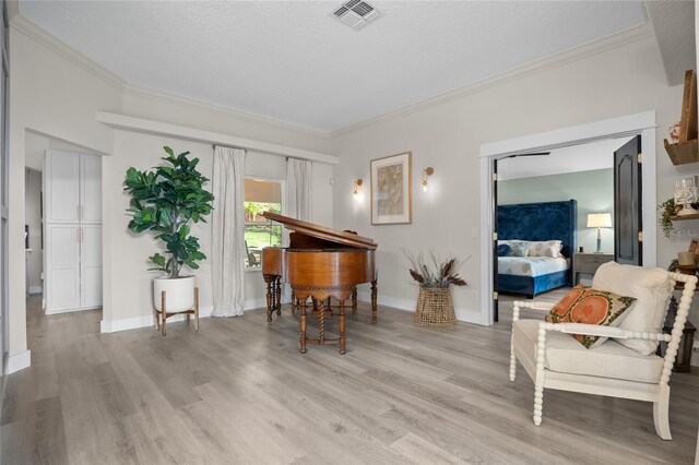 1301 Johns Cove Ln, Oakland, FL 34787 - sitting room with ornamental molding, light wood-style flooring, a textured ceiling, and baseboards