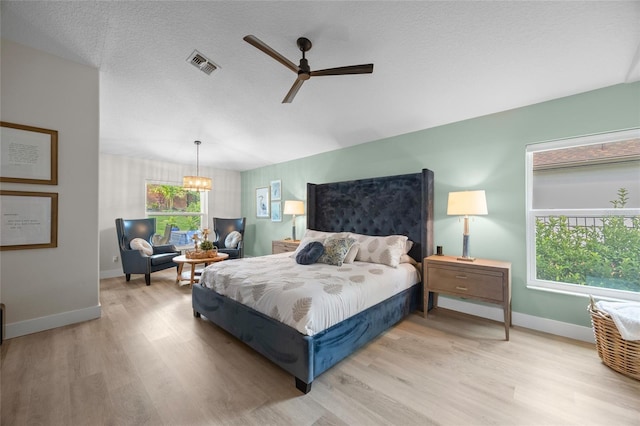 1301 Johns Cove Ln, Oakland, FL 34787 - bedroom with wood finished floors, baseboards, a chandelier, and a ceiling fan