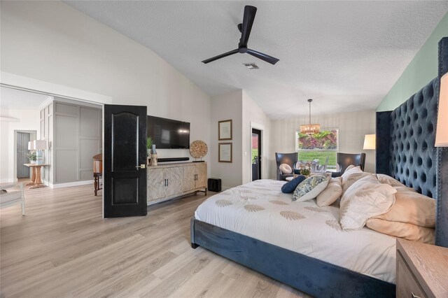 1301 Johns Cove Ln, Oakland, FL 34787 - bedroom with vaulted ceiling, wood finished floors, a chandelier, a textured ceiling, and ceiling fan