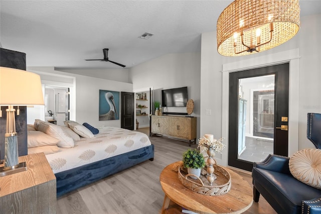 1301 Johns Cove Ln, Oakland, FL 34787 - bedroom featuring a chandelier, wood finished floors, vaulted ceiling, and a ceiling fan