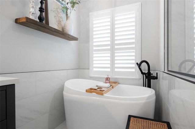1301 Johns Cove Ln, Oakland, FL 34787 - full bath featuring a freestanding bath, tile walls, and vanity