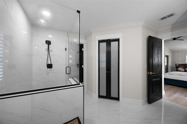 1301 Johns Cove Ln, Oakland, FL 34787 - ensuite bathroom with a stall shower, ornamental molding, baseboards, marble finish flooring, and a textured ceiling