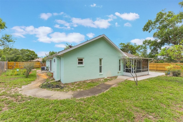 109 Hunter Point Ct, Debary, FL 32713 - rear view of house with a sunroom, stucco siding, and central air condition unit