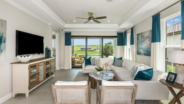 3142 Torta Ct, Bradenton, FL 34211 - living area featuring a ceiling fan, light tile patterned floors, baseboards, a raised ceiling, and crown molding