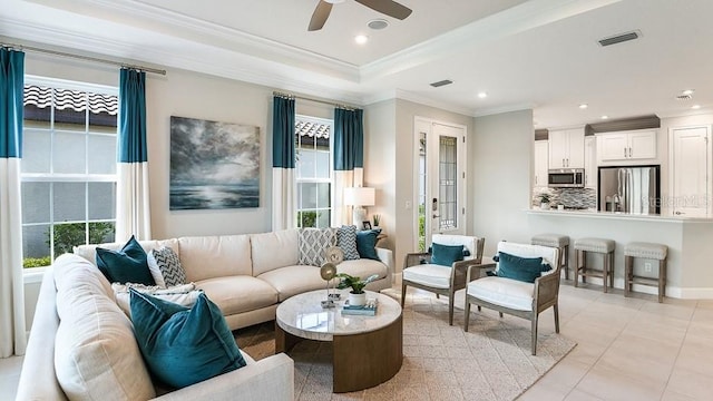 3142 Torta Ct, Bradenton, FL 34211 - living area with healthy amount of natural light, ceiling fan, crown molding, light tile patterned floors, and a raised ceiling