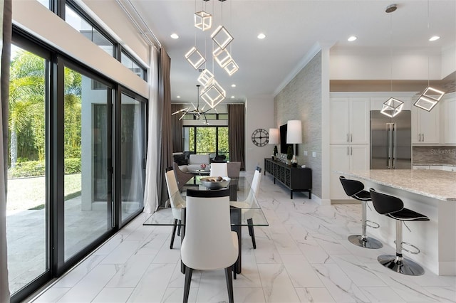 8113 Via Vittoria Way, Orlando, FL 32819 - dining space with crown molding, light marble finish flooring, and recessed lighting
