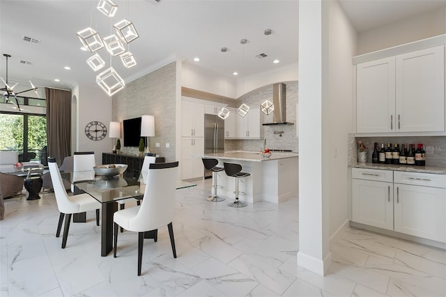 8113 Via Vittoria Way, Orlando, FL 32819 - dining room with light marble finish floors, ornamental molding, a chandelier, recessed lighting, and arched walkways