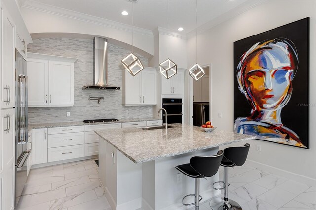 8113 Via Vittoria Way, Orlando, FL 32819 - kitchen with wall chimney exhaust hood, light marble finish floors, a sink, black appliances, and a kitchen island with sink