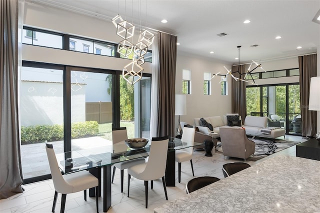 8113 Via Vittoria Way, Orlando, FL 32819 - dining area featuring a chandelier, light marble finish floors, recessed lighting, and ornamental molding