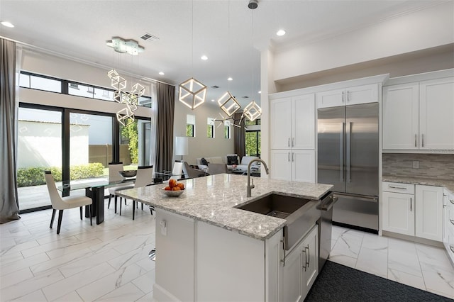 8113 Via Vittoria Way, Orlando, FL 32819 - kitchen featuring appliances with stainless steel finishes, light marble finish floors, a sink, crown molding, and recessed lighting