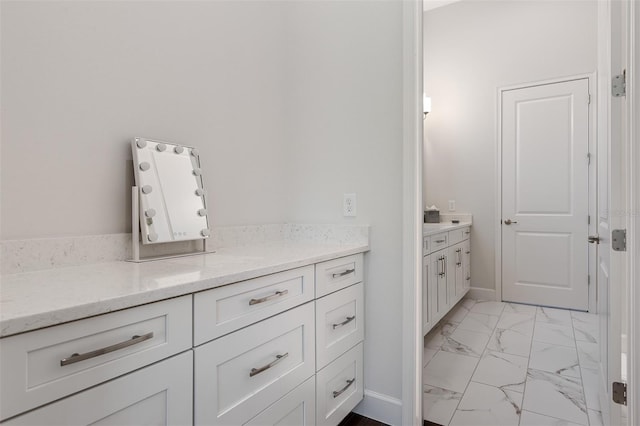 8113 Via Vittoria Way, Orlando, FL 32819 - bathroom featuring vanity, marble look tile flooring, and baseboards