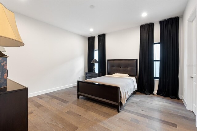 8113 Via Vittoria Way, Orlando, FL 32819 - bedroom featuring light wood-style flooring, recessed lighting, and baseboards