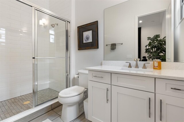 8113 Via Vittoria Way, Orlando, FL 32819 - bathroom featuring toilet, vanity, and a shower stall