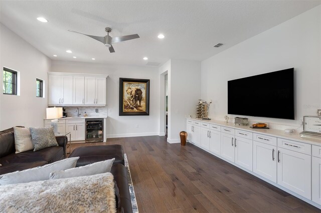 8113 Via Vittoria Way, Orlando, FL 32819 - living area featuring beverage cooler, ceiling fan, dark wood-style flooring, recessed lighting, and baseboards