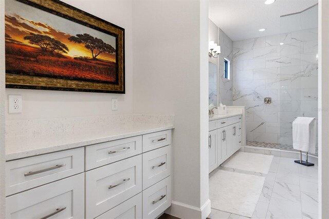 8113 Via Vittoria Way, Orlando, FL 32819 - bathroom featuring marble look tiles, a marble finish shower, vanity, and recessed lighting