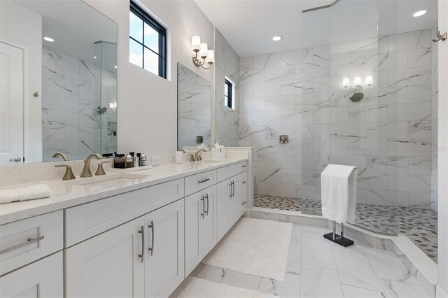 8113 Via Vittoria Way, Orlando, FL 32819 - bathroom with a marble finish shower, marble look tile flooring, double vanity, and recessed lighting