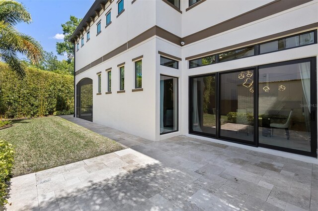 8113 Via Vittoria Way, Orlando, FL 32819 - entrance to property featuring stucco siding and a patio