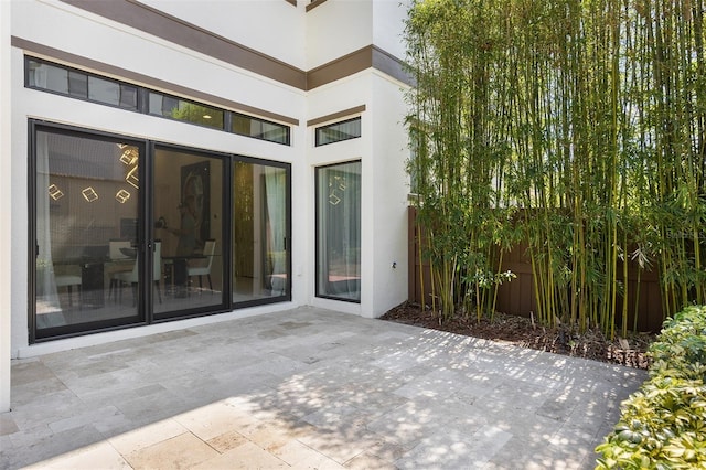 8113 Via Vittoria Way, Orlando, FL 32819 - view of exterior entry featuring stucco siding and a patio