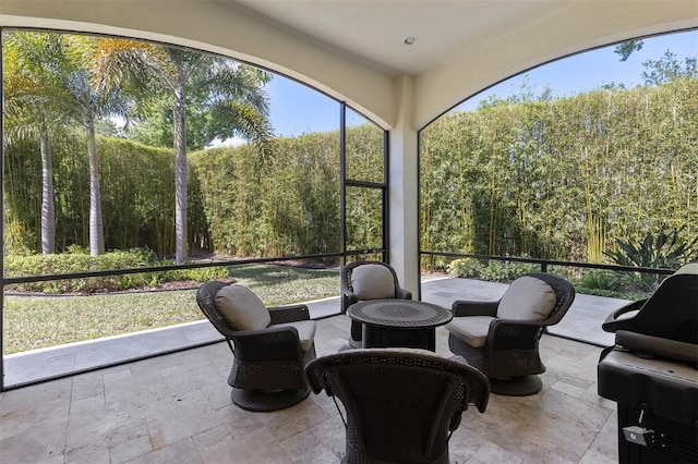 8113 Via Vittoria Way, Orlando, FL 32819 - sunroom / solarium featuring stone tile floors and a view of trees