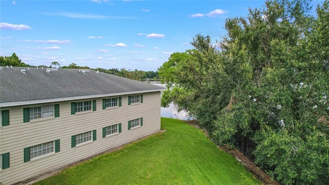 2893 S Osceola Ave Unit E6, Orlando, FL 32806 - view of side of home featuring a lawn and a shingled roof
