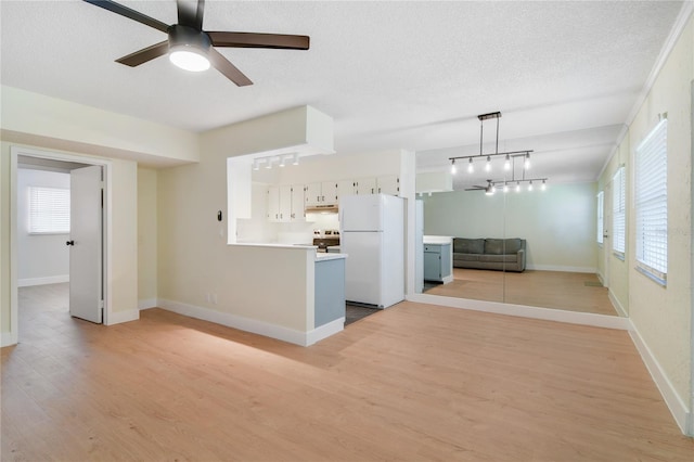 2893 S Osceola Ave Unit E6, Orlando, FL 32806 - unfurnished living room featuring a ceiling fan, light wood-style flooring, baseboards, and a textured ceiling