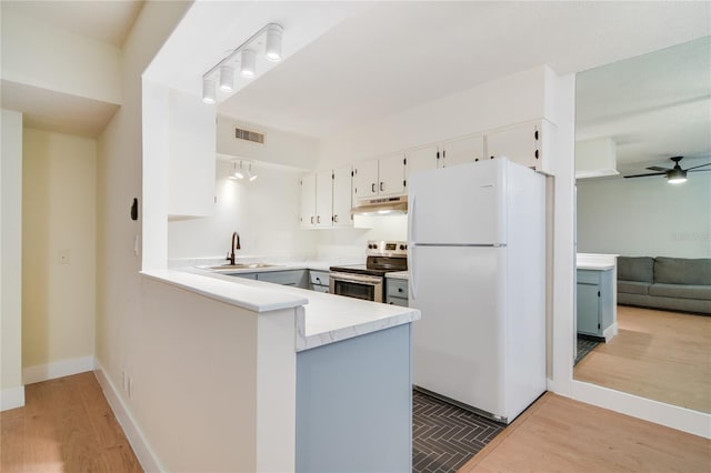 2893 S Osceola Ave Unit E6, Orlando, FL 32806 - kitchen with freestanding refrigerator, stainless steel range with electric stovetop, under cabinet range hood, a sink, and wood finished floors