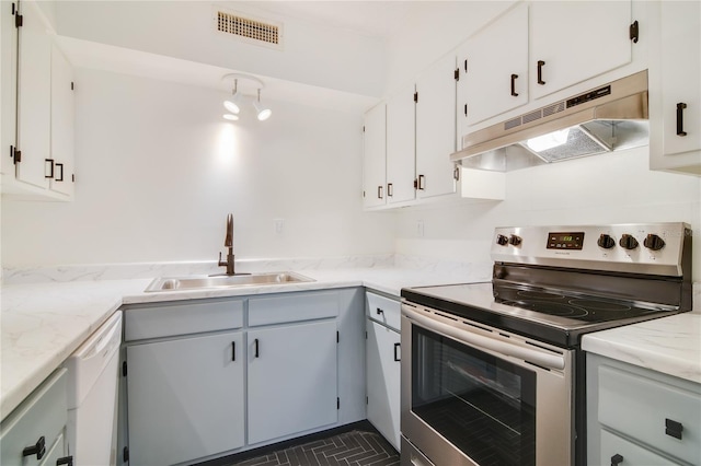 2893 S Osceola Ave Unit E6, Orlando, FL 32806 - kitchen featuring stainless steel range with electric stovetop, a sink, under cabinet range hood, white dishwasher, and white cabinetry