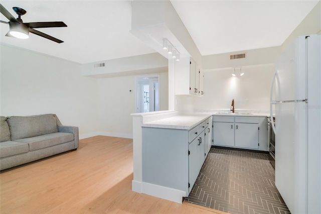 2893 S Osceola Ave Unit E6, Orlando, FL 32806 - kitchen with freestanding refrigerator, a sink, open floor plan, a ceiling fan, and light countertops