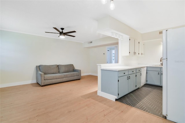 2893 S Osceola Ave Unit E6, Orlando, FL 32806 - kitchen with freestanding refrigerator, a ceiling fan, baseboards, and wood finished floors
