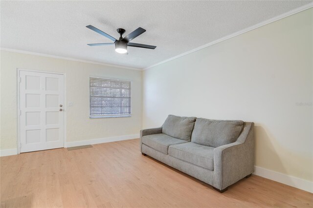 2893 S Osceola Ave Unit E6, Orlando, FL 32806 - living area featuring ornamental molding, light wood-type flooring, a textured ceiling, a ceiling fan, and baseboards