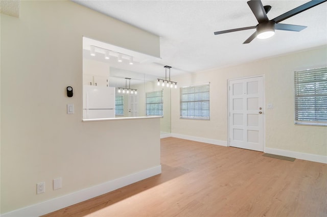 2893 S Osceola Ave Unit E6, Orlando, FL 32806 - spare room featuring ceiling fan, light wood-style flooring, baseboards, and a textured ceiling