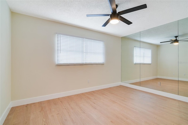 2893 S Osceola Ave Unit E6, Orlando, FL 32806 - spare room with a textured ceiling, ceiling fan, light wood-style floors, and baseboards